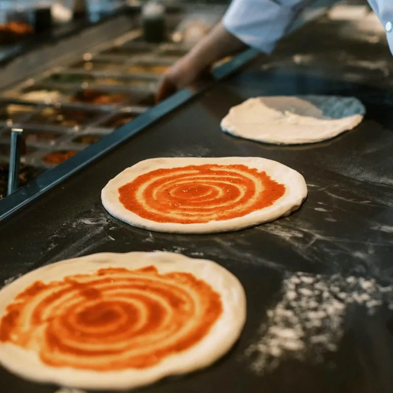 Pizzas being prepared